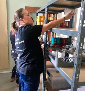 M&S volunteers doing a great job organising the shelves with food.